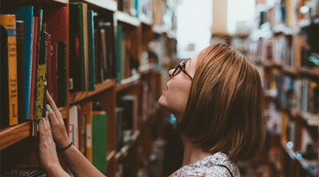 Lady looking on book shelf