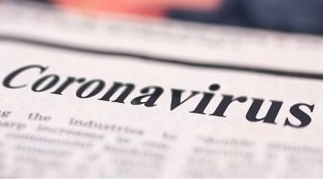 Newspaper with Coronavirus printed in the headline.