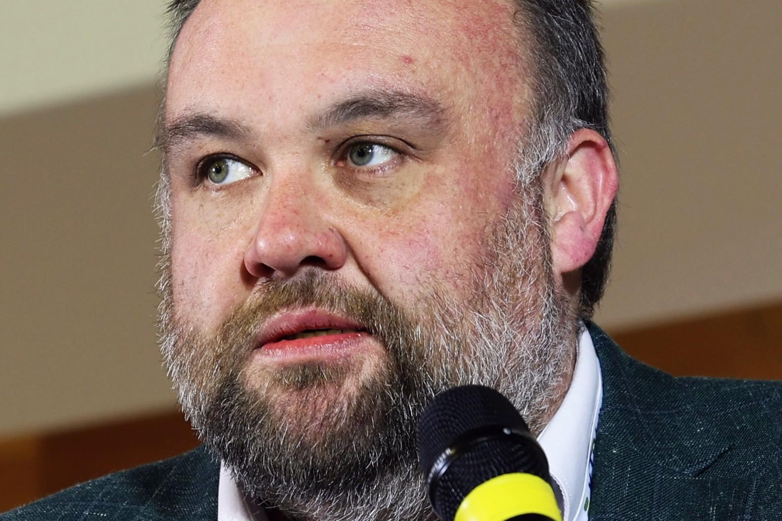 manager speaking in to microphone