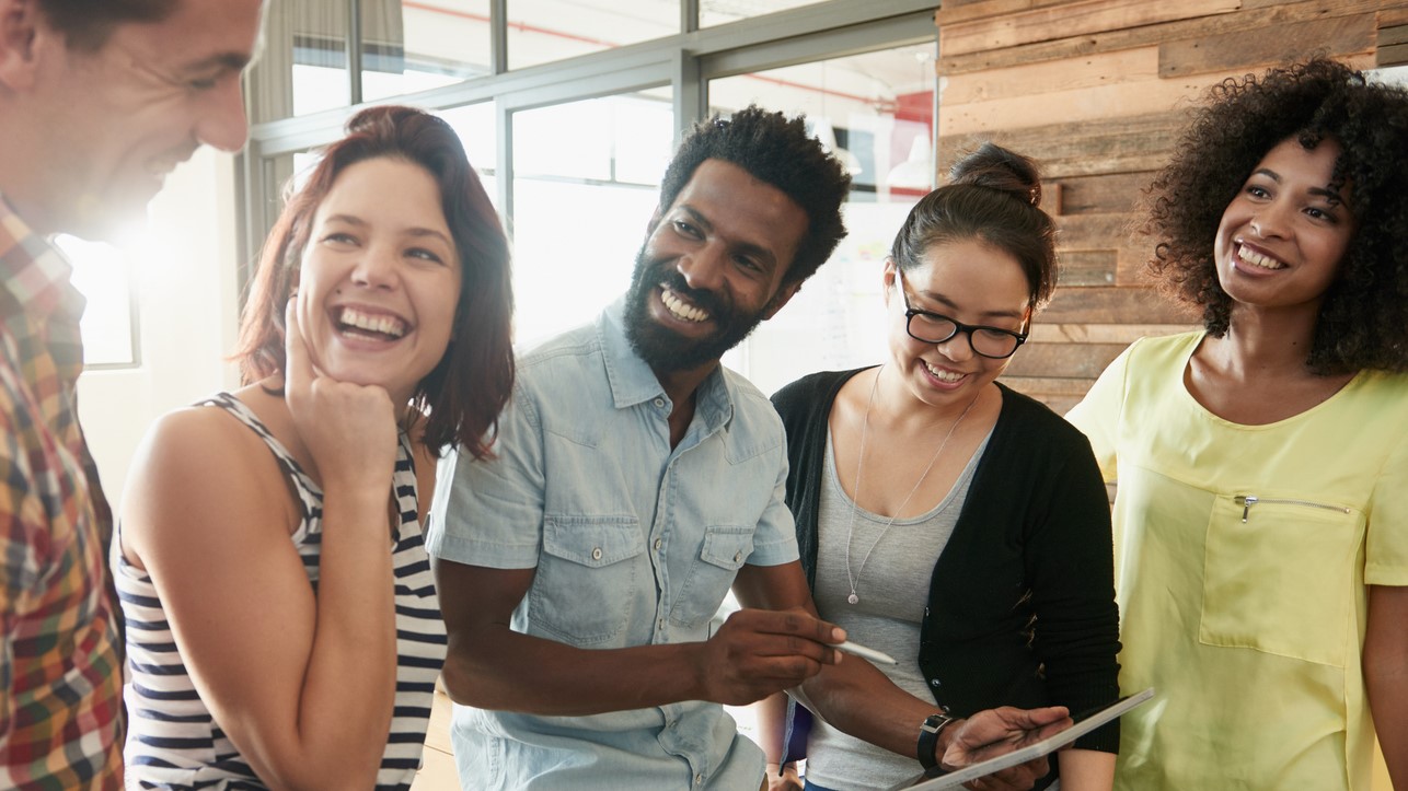 young people standing together laughing