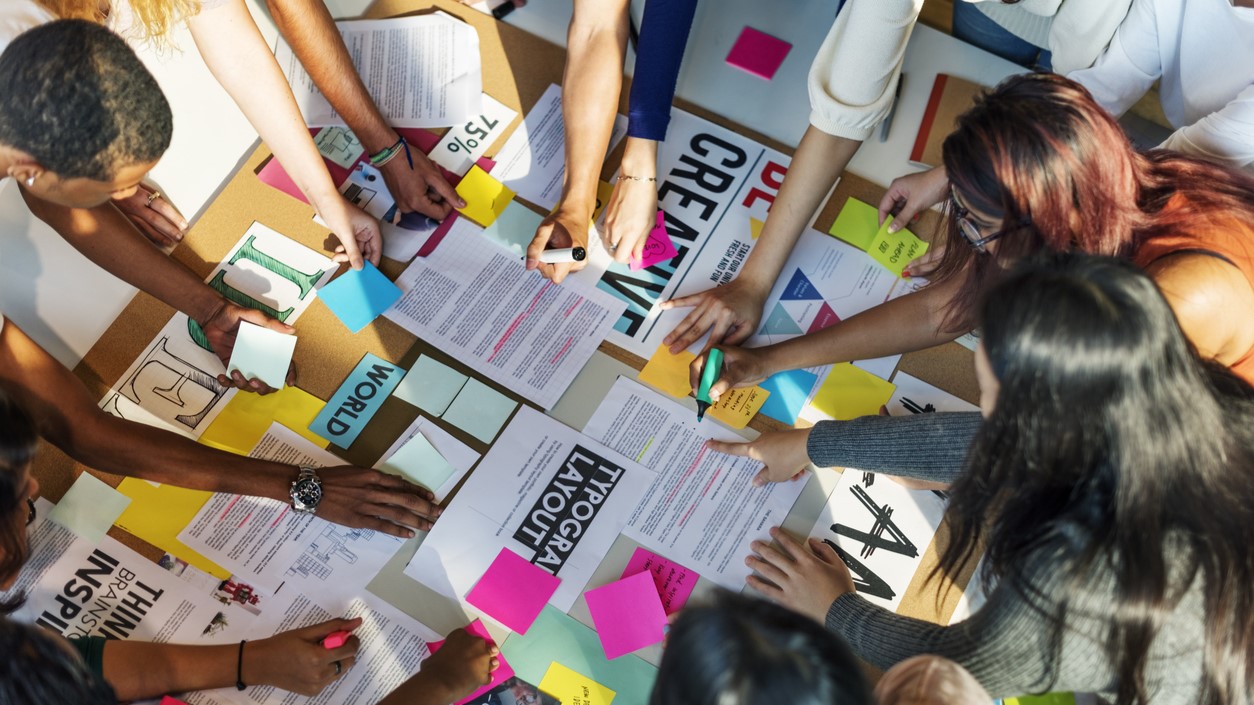 people compiling ideas on paper