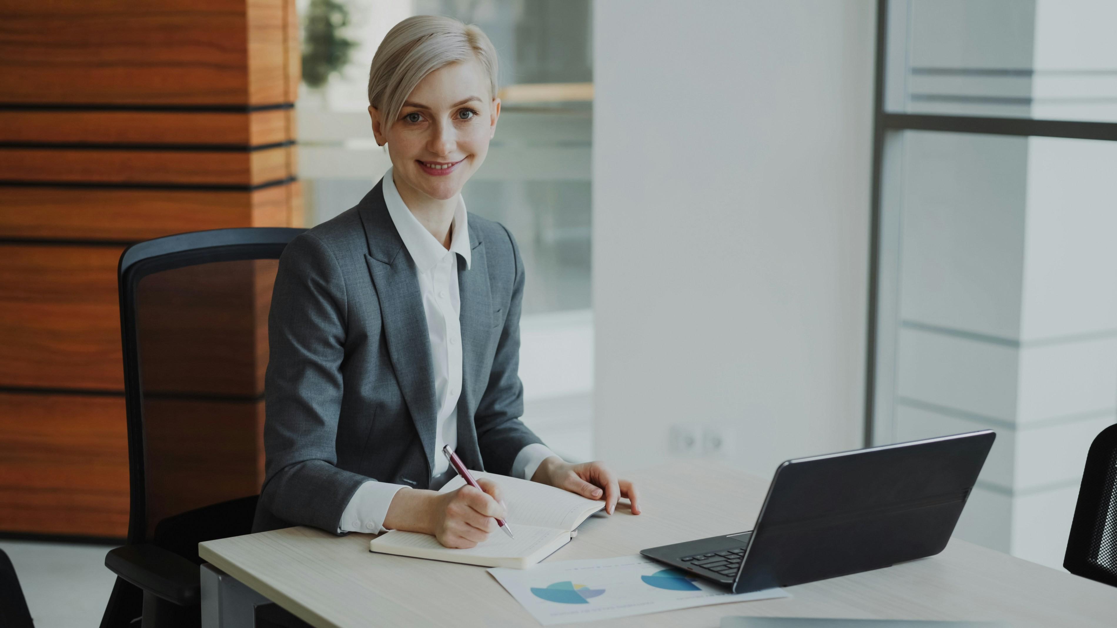 person sitting at desk writing